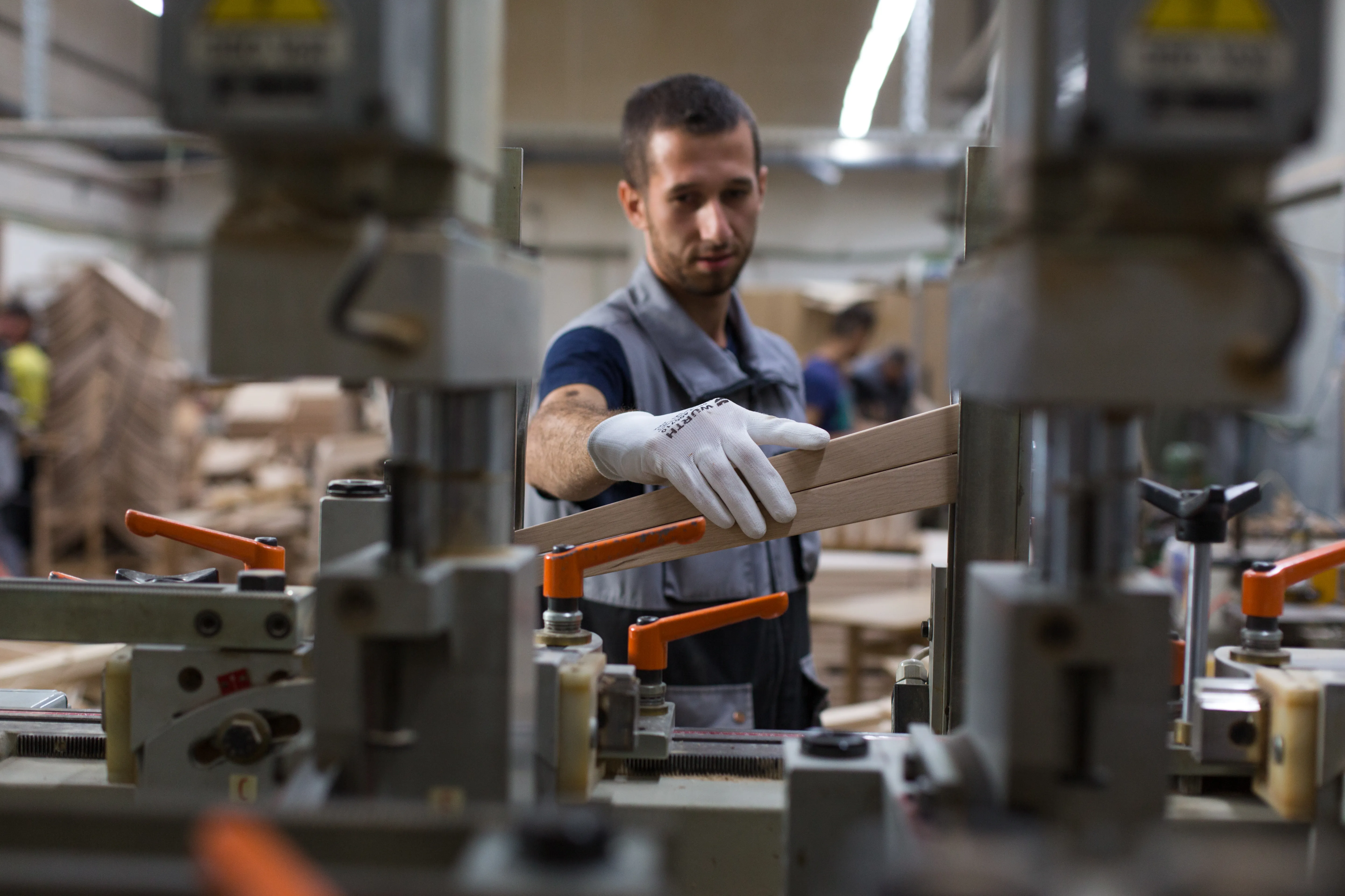 A Wood Team machinist at a shaping station.